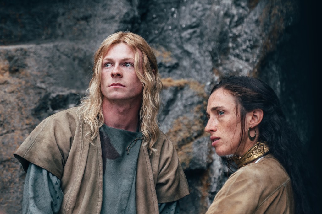 Stuart Campbell as Derfel and Ellie James as Nimue looking serious against a wall. 