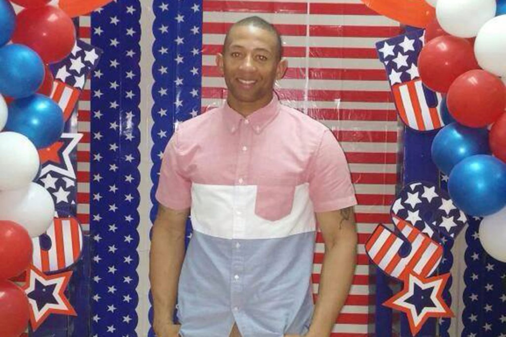 US Army vet Dynell Lane smiling in a photo in front of American flag decorations.