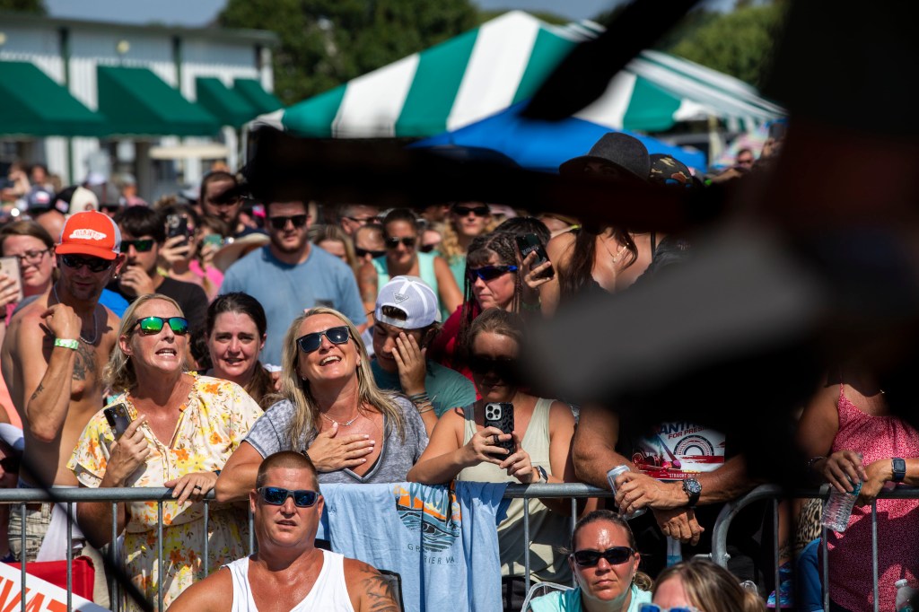 Fans sing along with Oliver Anthony as he performs at Eagle Creek Golf Club and Grill in Moyock, N.C., on Saturday, Aug. 19, 2023. (
