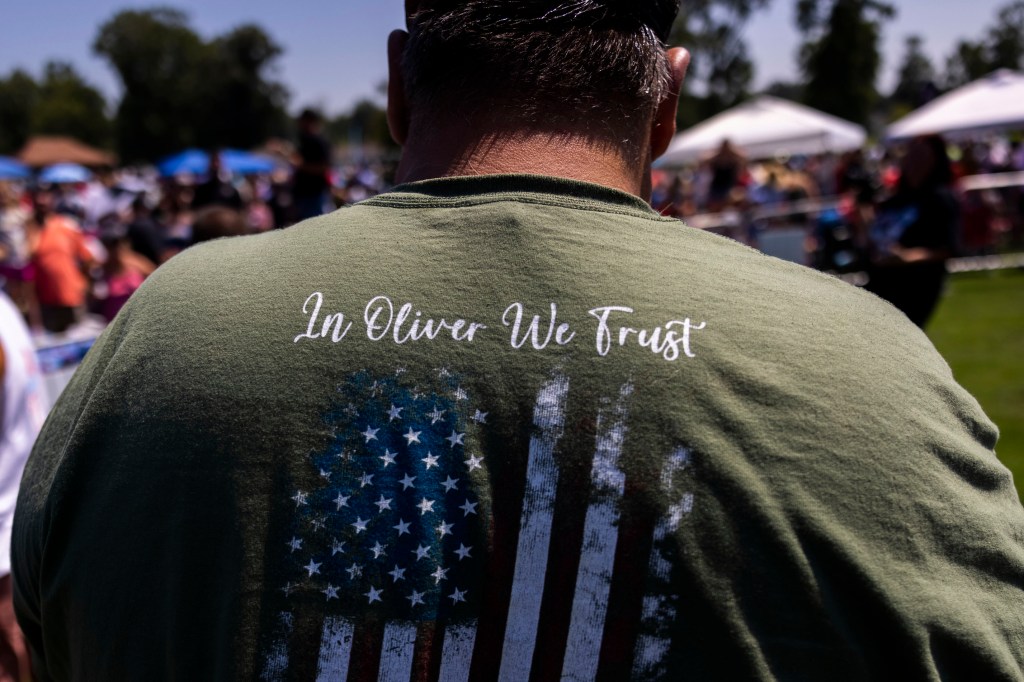 Man wearing In Oliver We Trust tee shirt