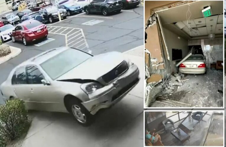 Runaway car slams into beauty salon — missing patron by mere feet — in heart-pounding new video