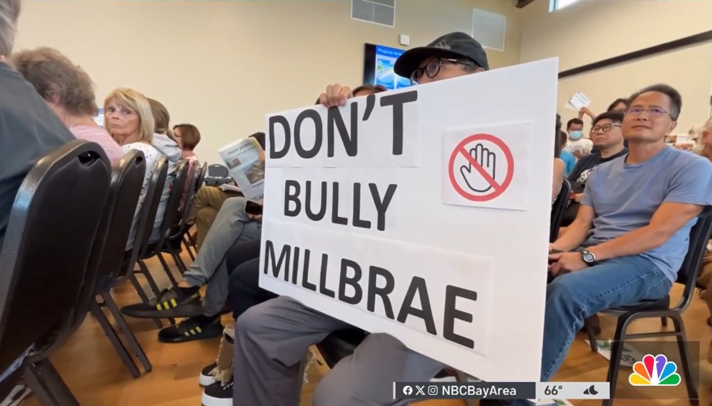 A sign accusing San Mateo County of bullying Millbrae with the plan.