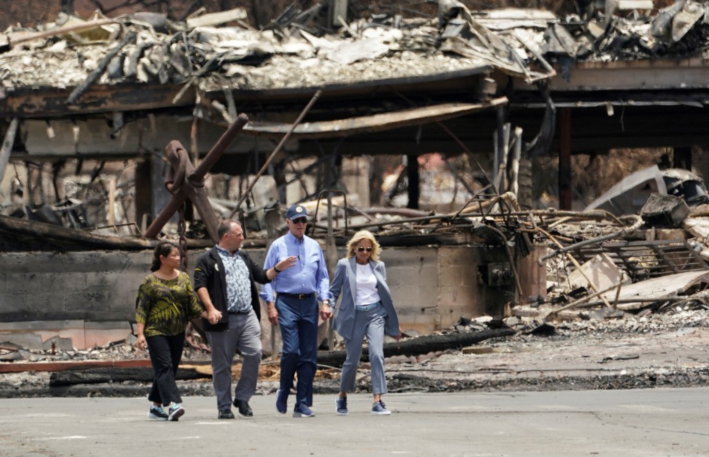 U.S. President Joe Biden and first lady Jill Biden walk with Hawaii Governor Josh Green and his wife Jaime Green as they tour the fire-ravaged town of Lahaina on the island of Maui in Hawaii