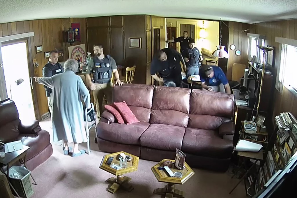 A screen grab of security camera footage provided by Eric Meyer shows his mother, Joan Meyer, ordering police officers to get out of her house as they searched it on Aug. 11, 2023, in Marion, Kansas.