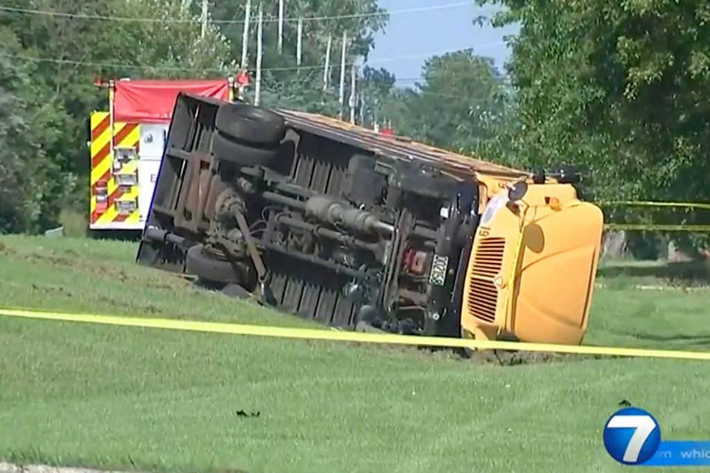 The bus landed on its side after colliding with the Honda.