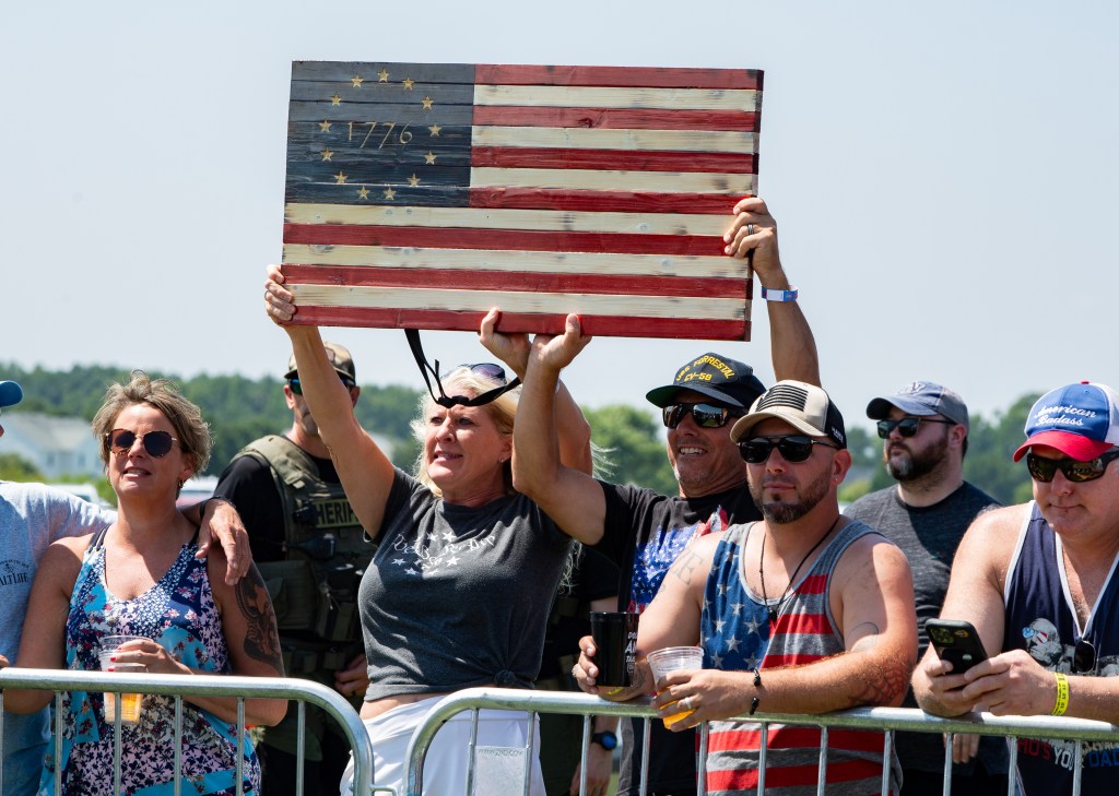 Fans raising american flag