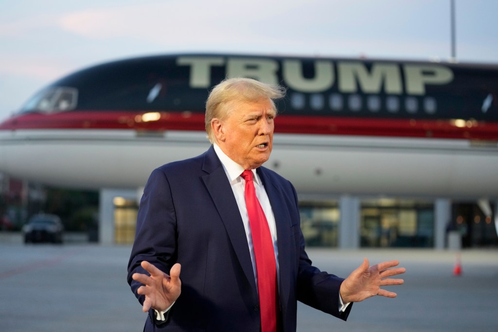 Former President Donald Trump speaks with reporters before departure from Hartsfield-Jackson Atlanta International Airport.