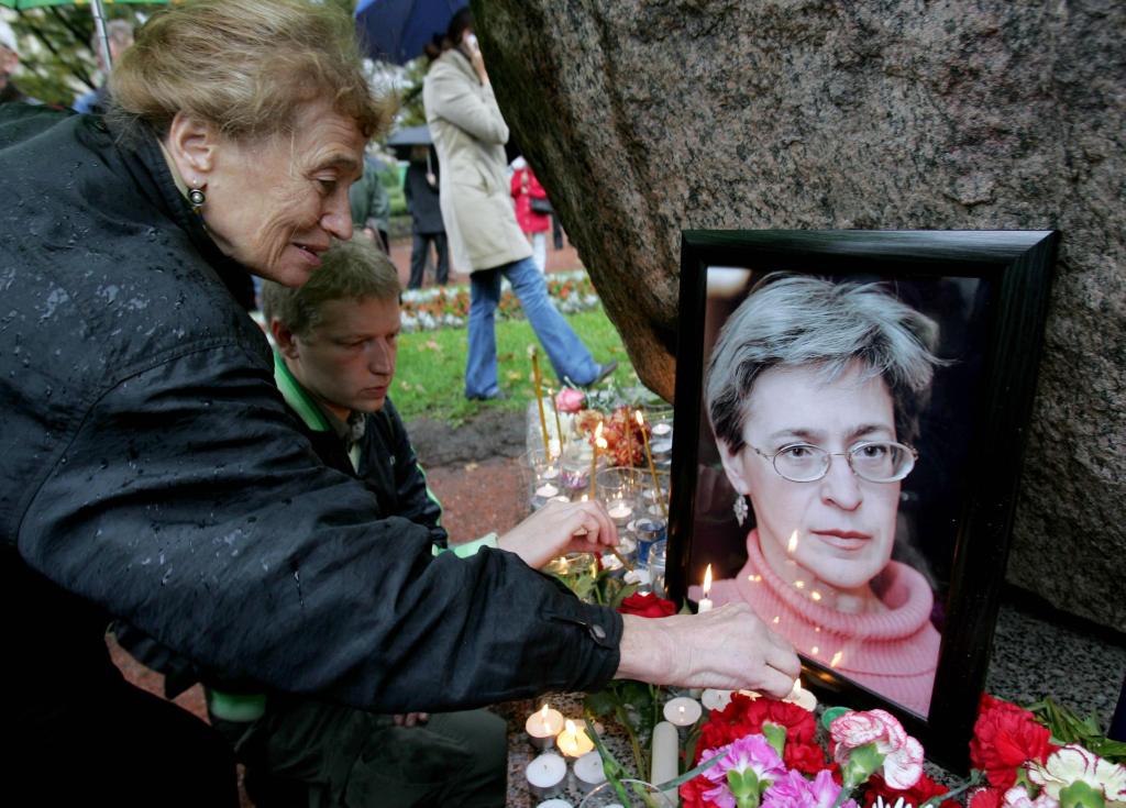 People light candles next to a portrait of Russian journalist Anna Politkovskaya during a rally in St. Petersburg October 8, 2006