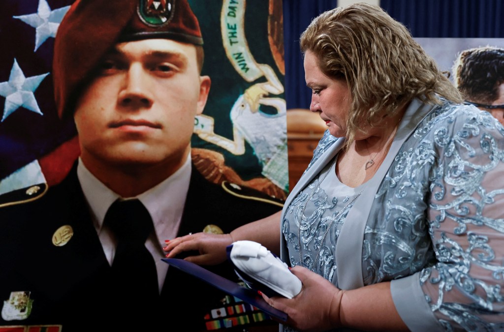 Paula Knauss Selph with a picture of her son Army Staff Sergeant Ryan Christian Knauss.