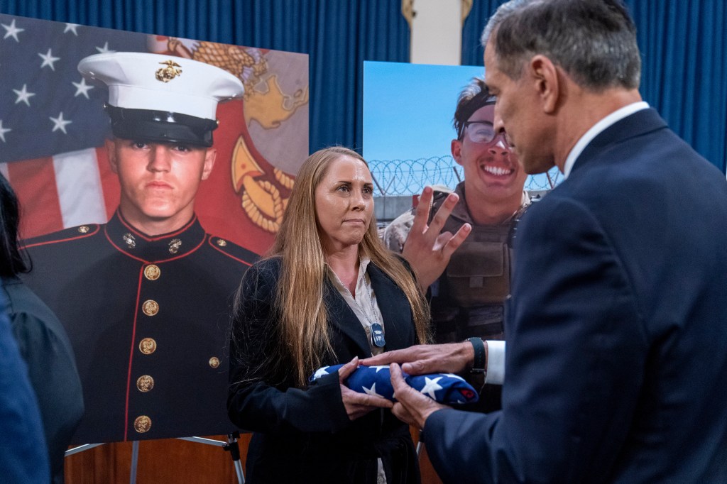 Rep. Darrell Issa presenting Cheryl Rex, mother of Marine Corps Lance Cpl. Dylan R. Merola, a flag that was flown over the Capitol building.