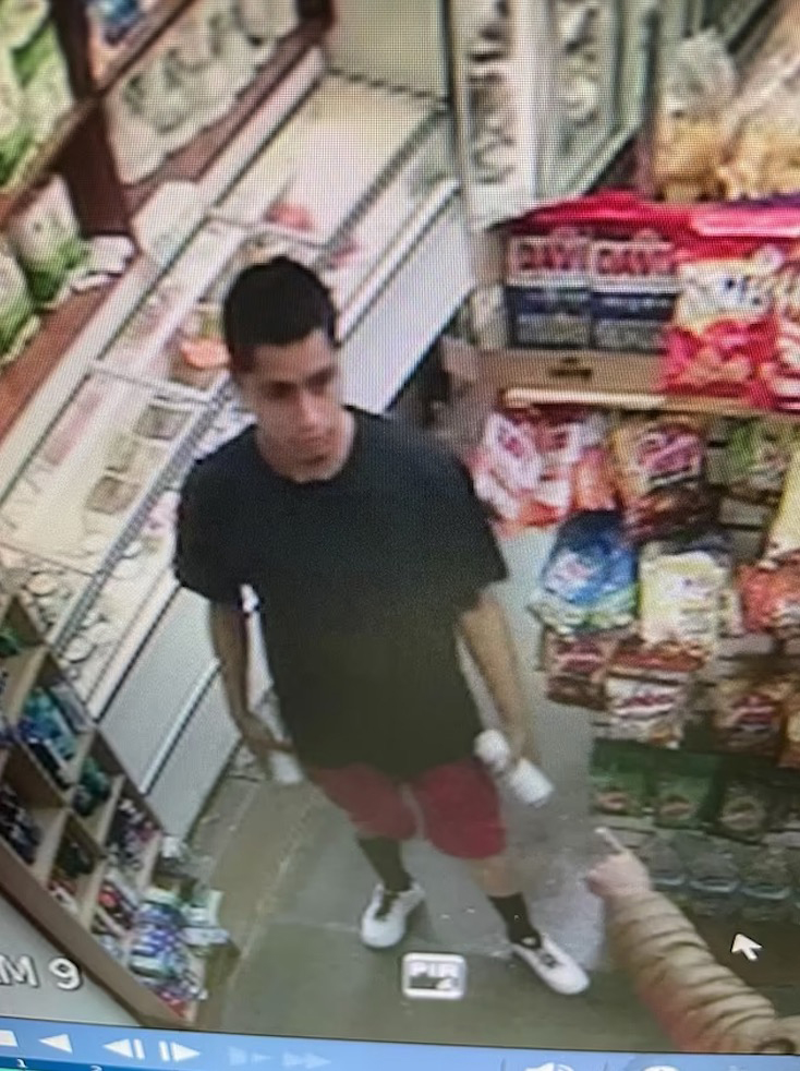 An image of the thief, in a black t-shirt and red shorts.