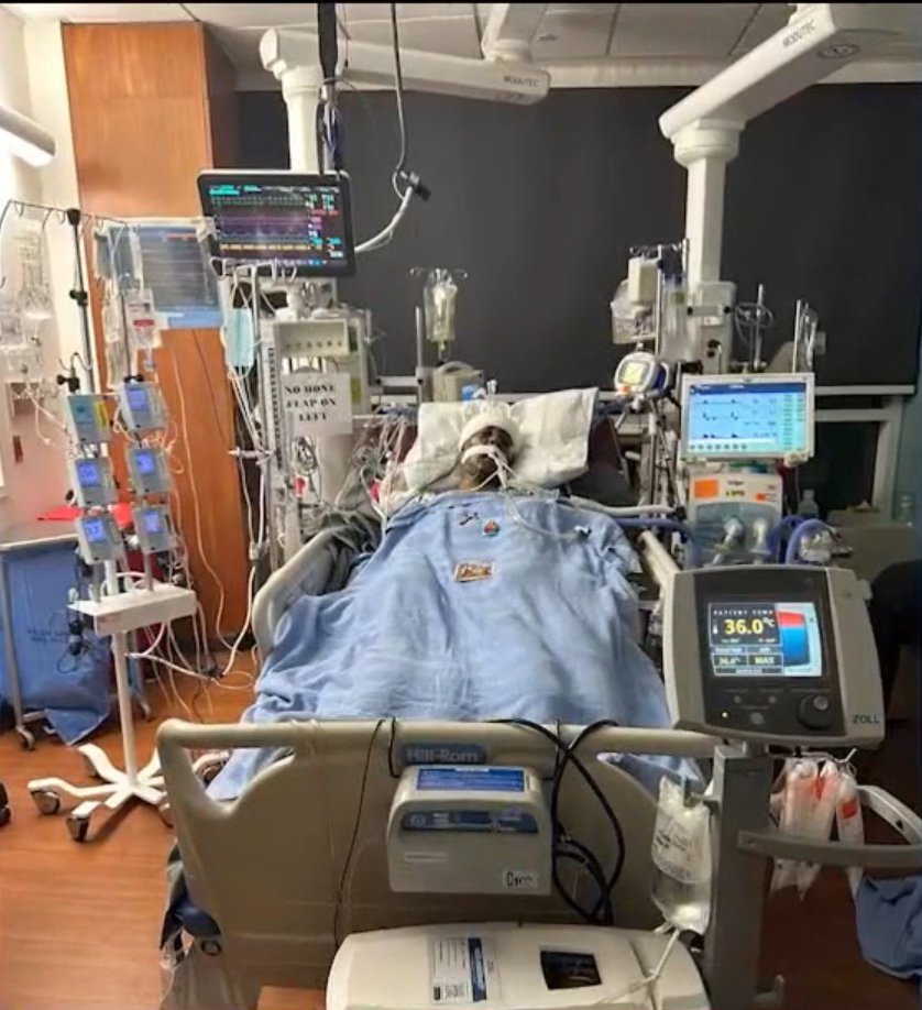Tewelde is pictured in the hospital hooked up to several machines.