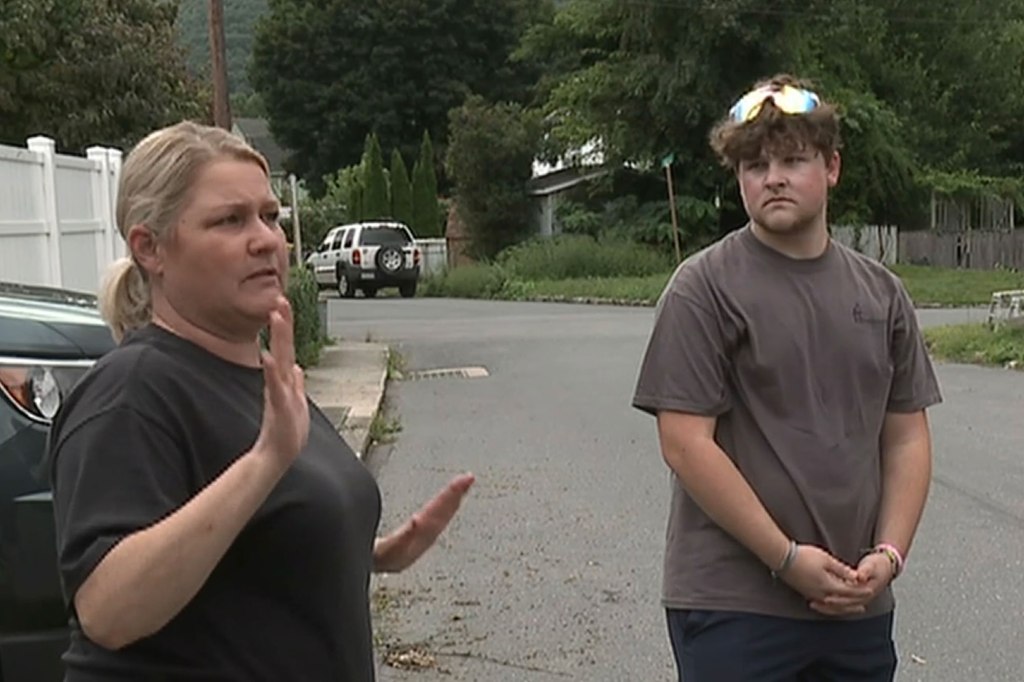 Maria Lahr talks as she stands on a residential street with her son Curtis. 
