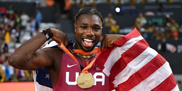 Noah Lyles poses with gold medal