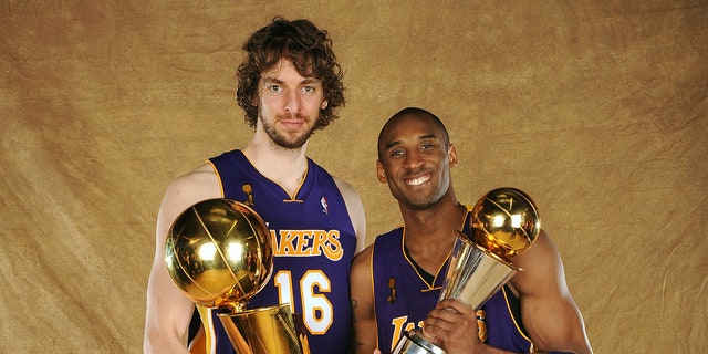 Pau Gasol and Kobe Bryant pose with trophies