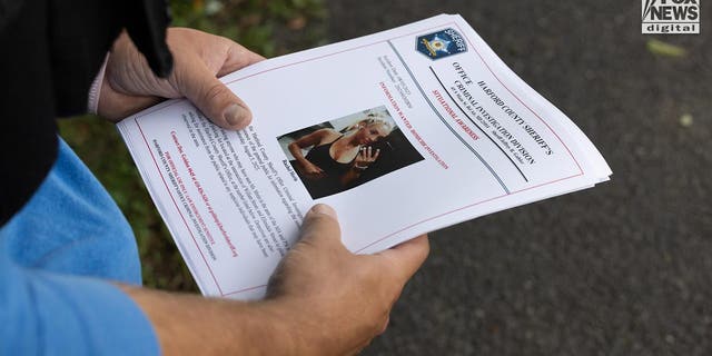 A closeup of hands holding flyers