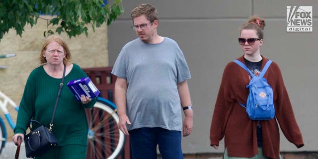 Rex Heuermann's wife, Asa Ellerup and daughter, Victoria Heuermann walk on the street