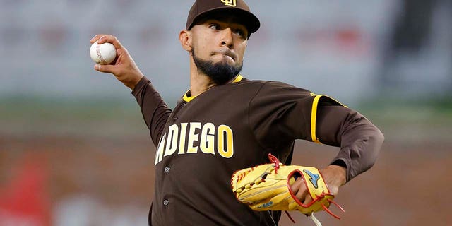 Robert Suarez pitches during a game