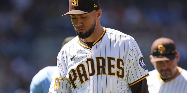 Robert Suarez looks down on field