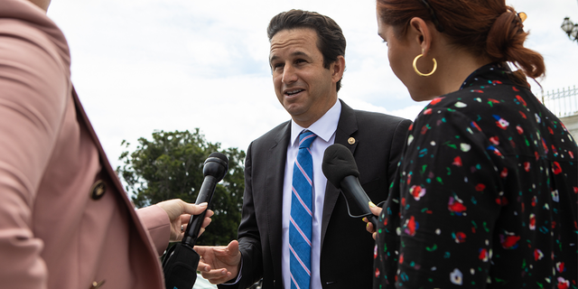 Sen Brian Schatz talks to reporters outside