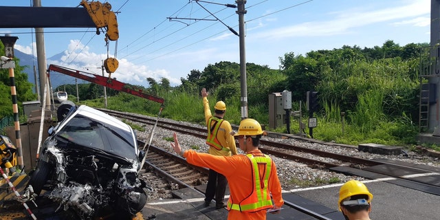 Car removed from site of crash with train