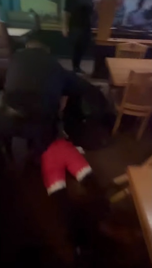 One officer was seen repeatedly beating on the man as he was being held down.