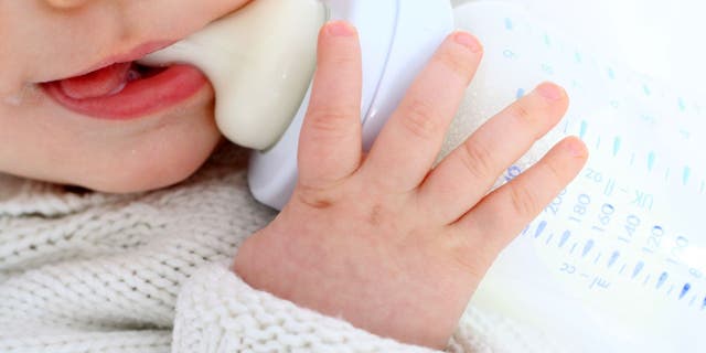 Baby drinks from bottle