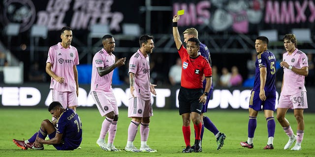 Lionel Messi gets a yellow card