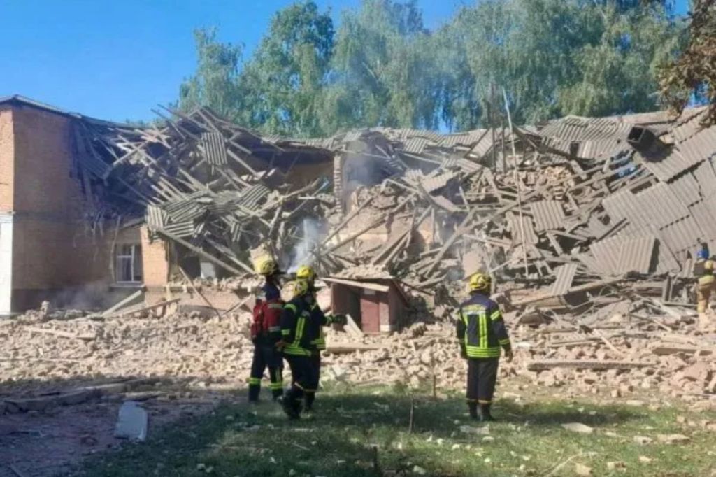 More rescuers are spotted at the site of a Russian drone strike that killed two teachers and wounded three others in Romny, Ukraine, on Aug. 23, 2023.