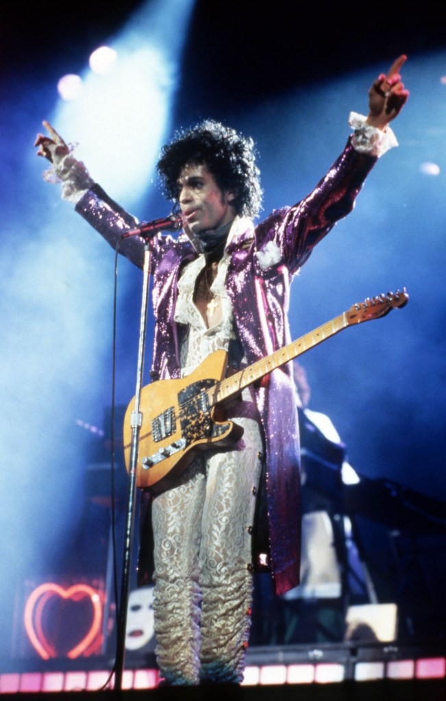 Prince performs onstage during the 1984 Purple Rain Tour