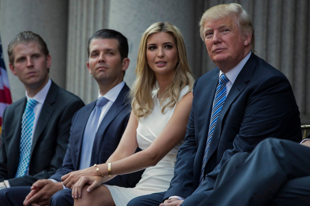Donald Trump sits with kids Eric, Don. Jr. and Ivanka.