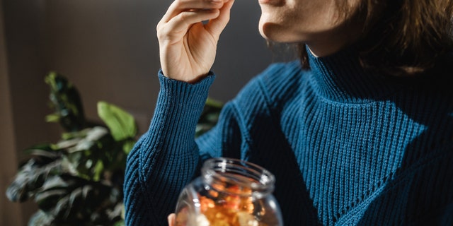 Woman taking gummies