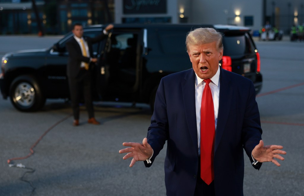 Trump speaks to the media at Atlanta Hartsfield-Jackson International Airport after surrendering at the Fulton County jail on August 24, 2023 in Atlanta, Georgia