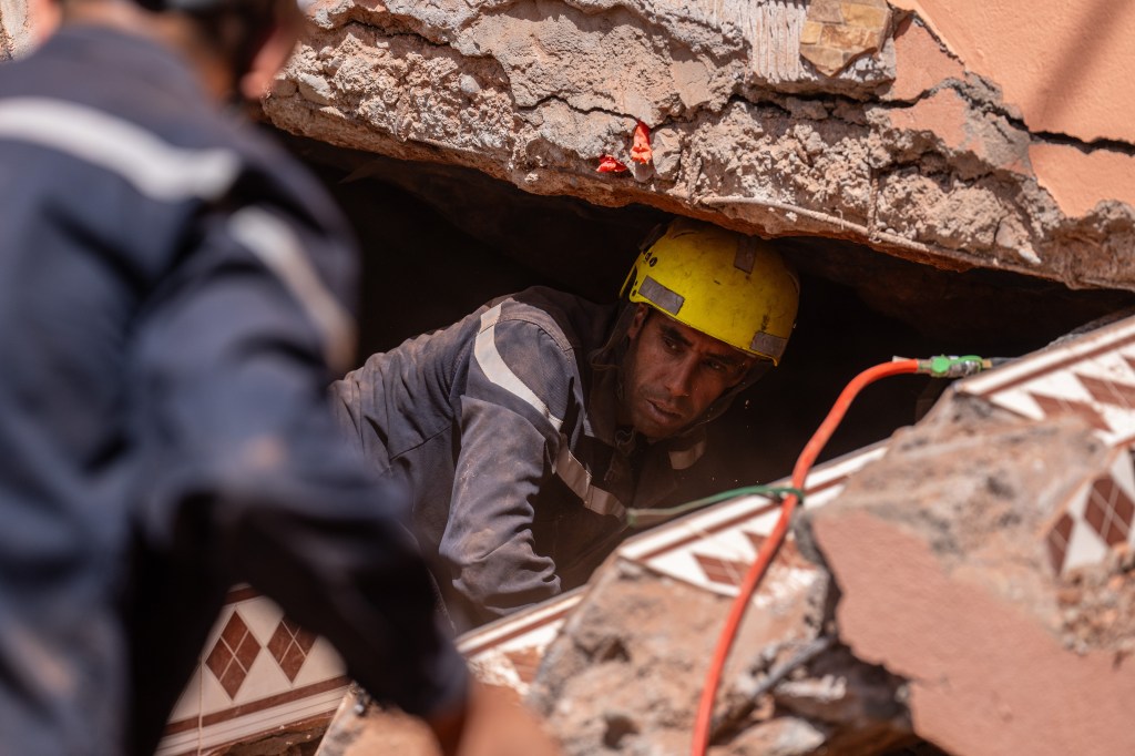 Emergency workers search beneath a heavily damaged house in Moulay Brahim, Morocco. 