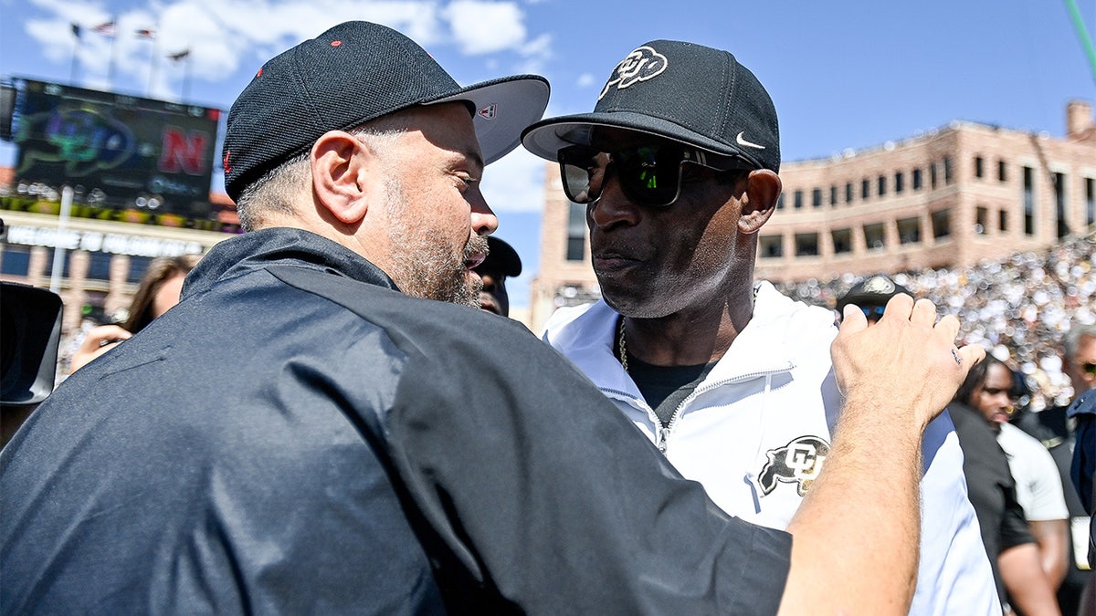 Matt Rhule and Deion Sanders hug