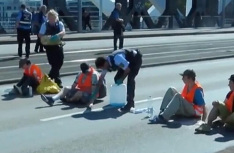 German cop accused of dumping oil on climate protesters that blocked road