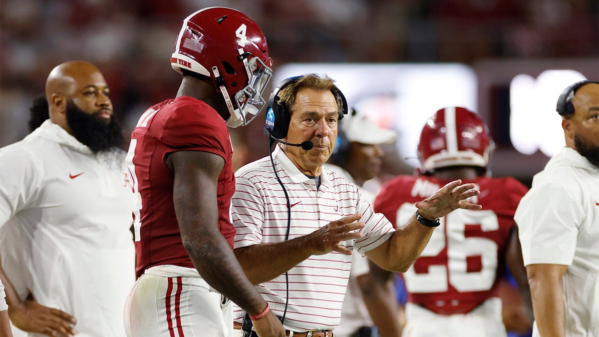 Nick Saban talks with Jalen Milroe