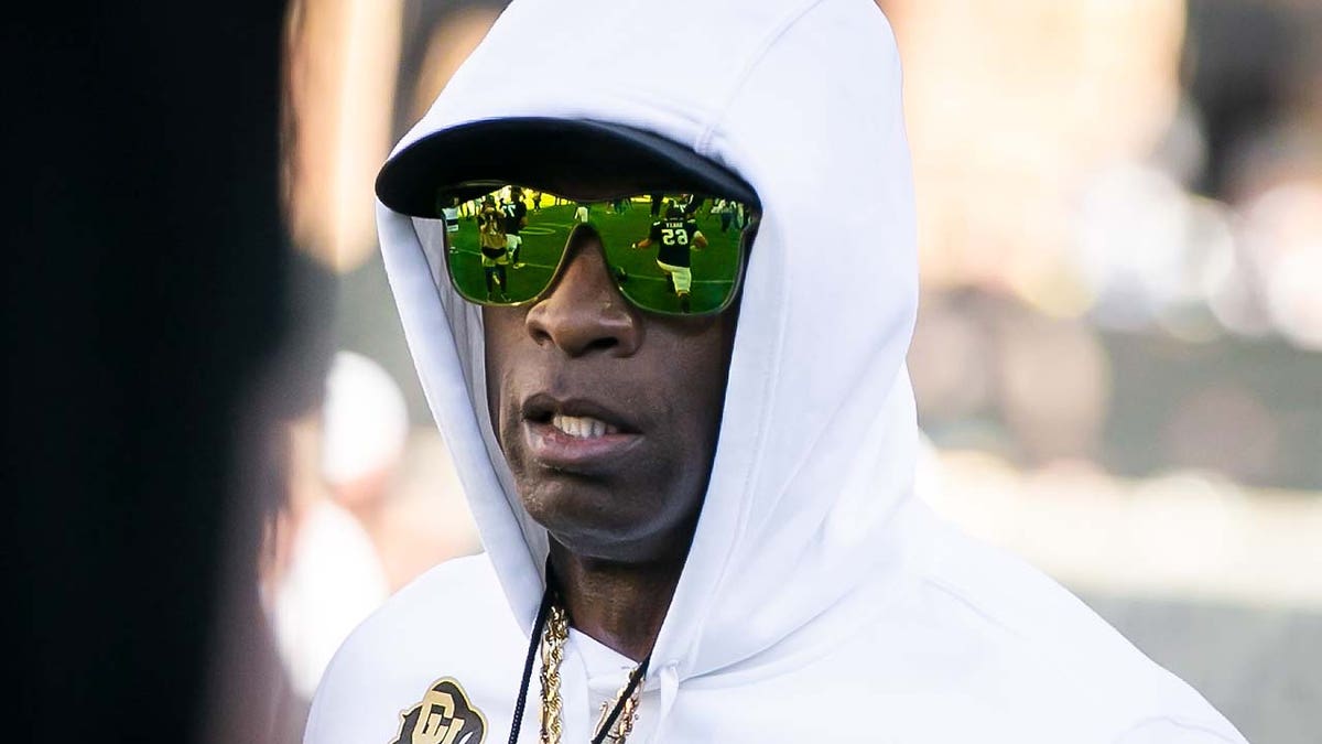 Deion Sanders walks during pregame warm ups