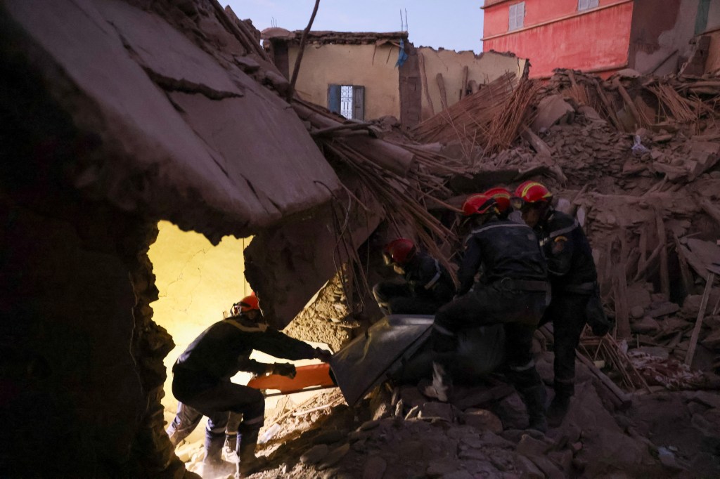 Emergency workers carry a dead body, in the aftermath of the deadly earthquake, in Amizmiz, Morocco. 