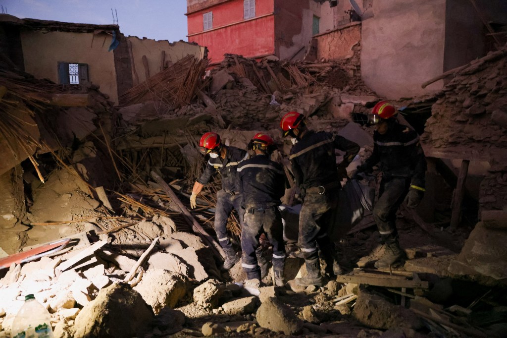Emergency workers carry a dead body, in the aftermath of a deadly earthquake, in Amizmiz, Morocco. 