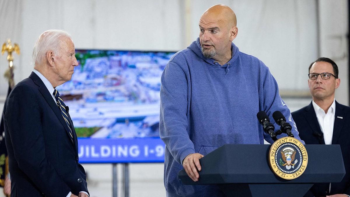 US President Joe Biden and Pennsylvania Governor Josh Shapiro look on as US Senator John Fetterman