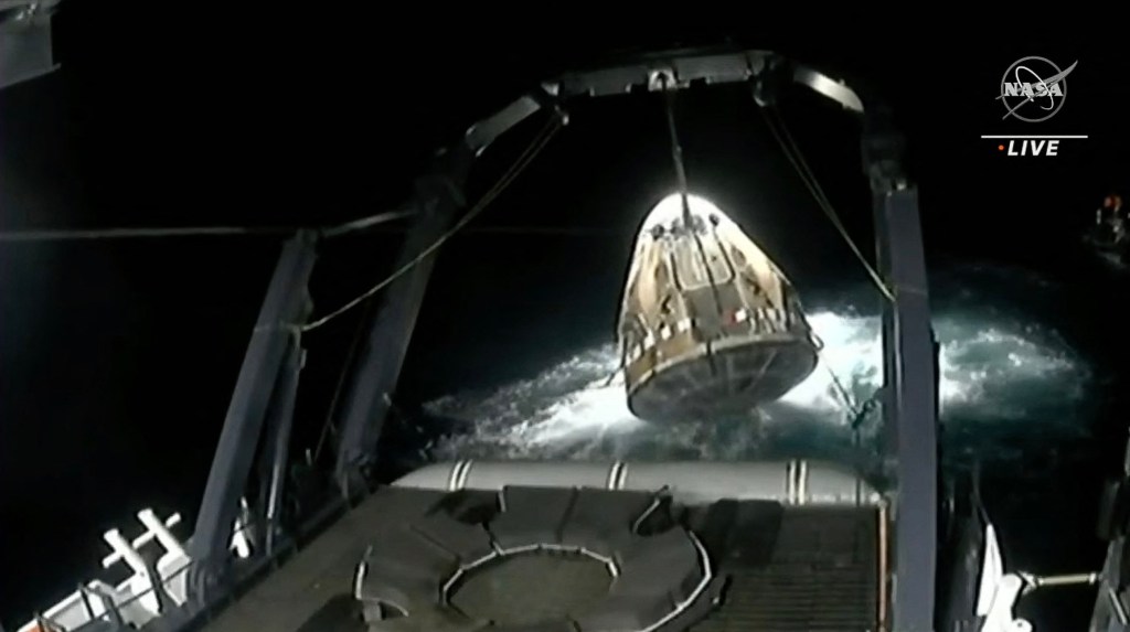 This screen grab taken from the NASA live feed shows the SpaceX Crew Dragon Endeavour spacecraft being lifted onto the recovery vessel after splashdown off the coast of Jacksonville on Sep. 4, 2023. 
