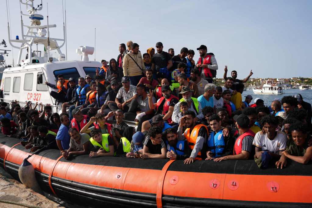 Migrants arrive in the harbour of Italian island of Lampedusa, on September 18, 2023.