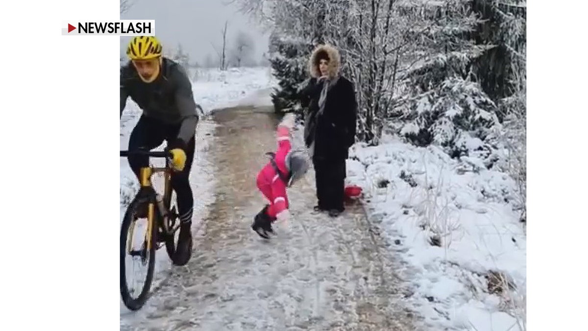 Belgian cyclist with girl and mom in background