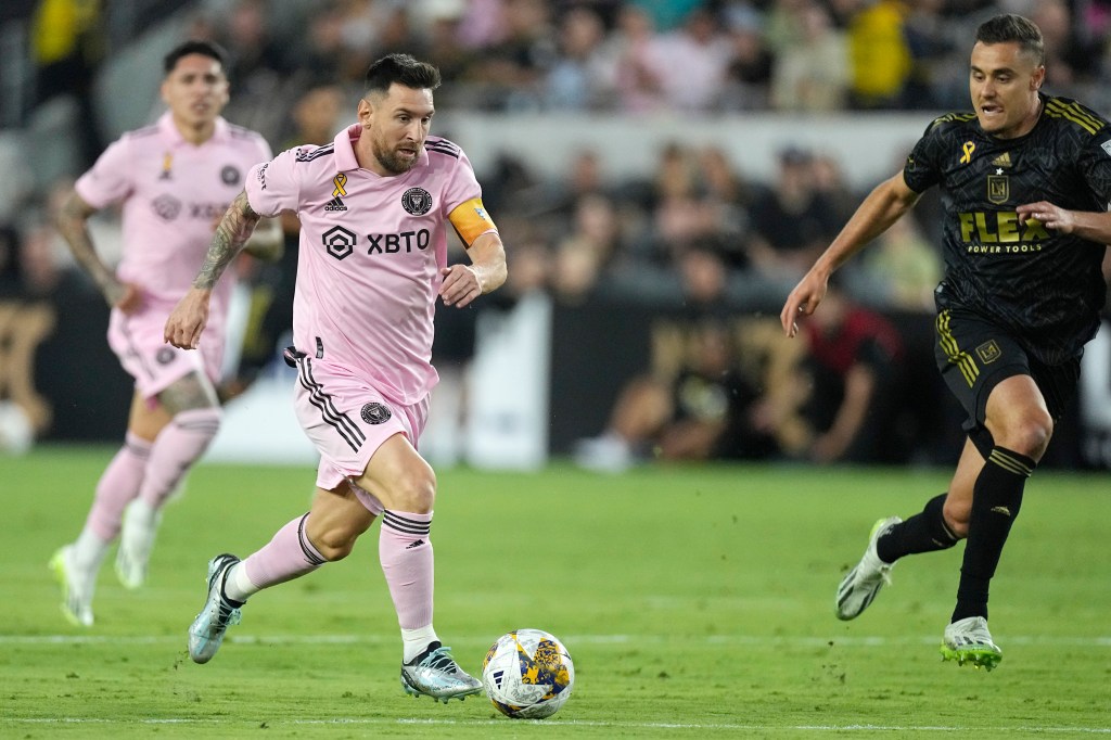 Inter Miami forward Lionel Messi, center, moves the ball as Los Angeles FC defender Aaron Long, right, chases during the first half of a Major League Soccer match on Sept. 3, 2023, in Los Angeles.