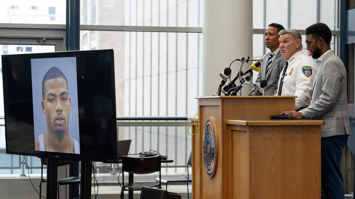 Officials deliver news briefing with mugshot of Jason Billingsley on screen