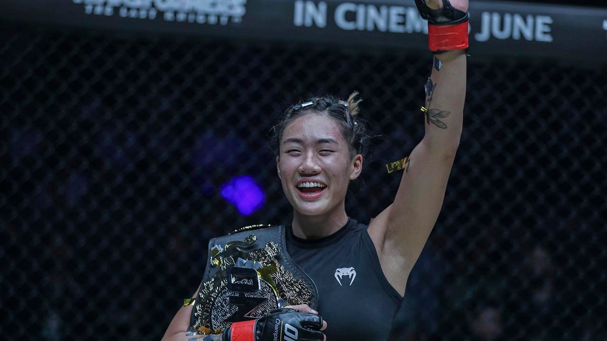 Angela Lee's hand raised