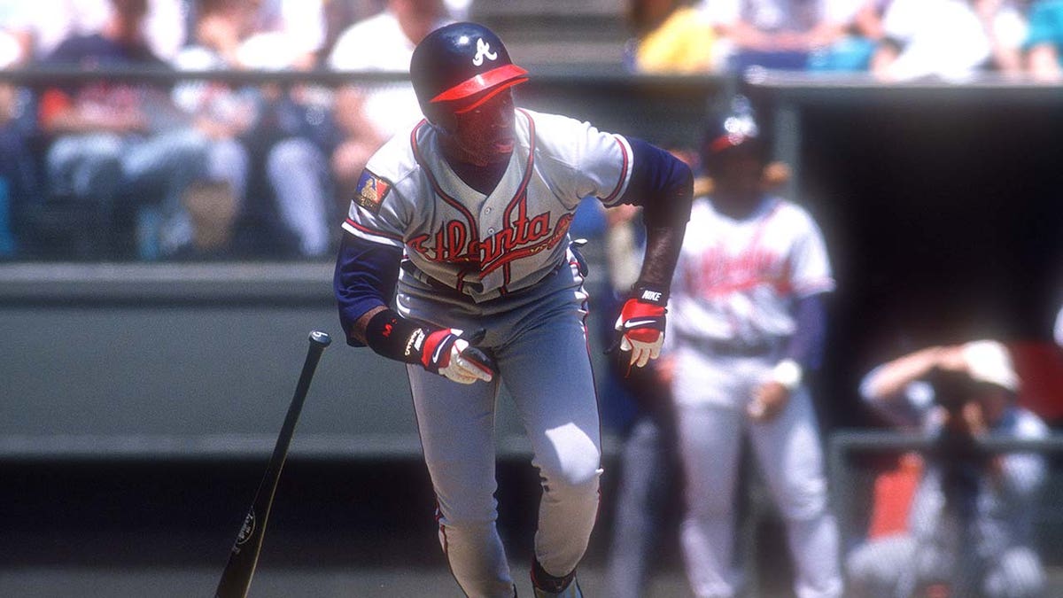 Deion Sanders swings the baseball bat