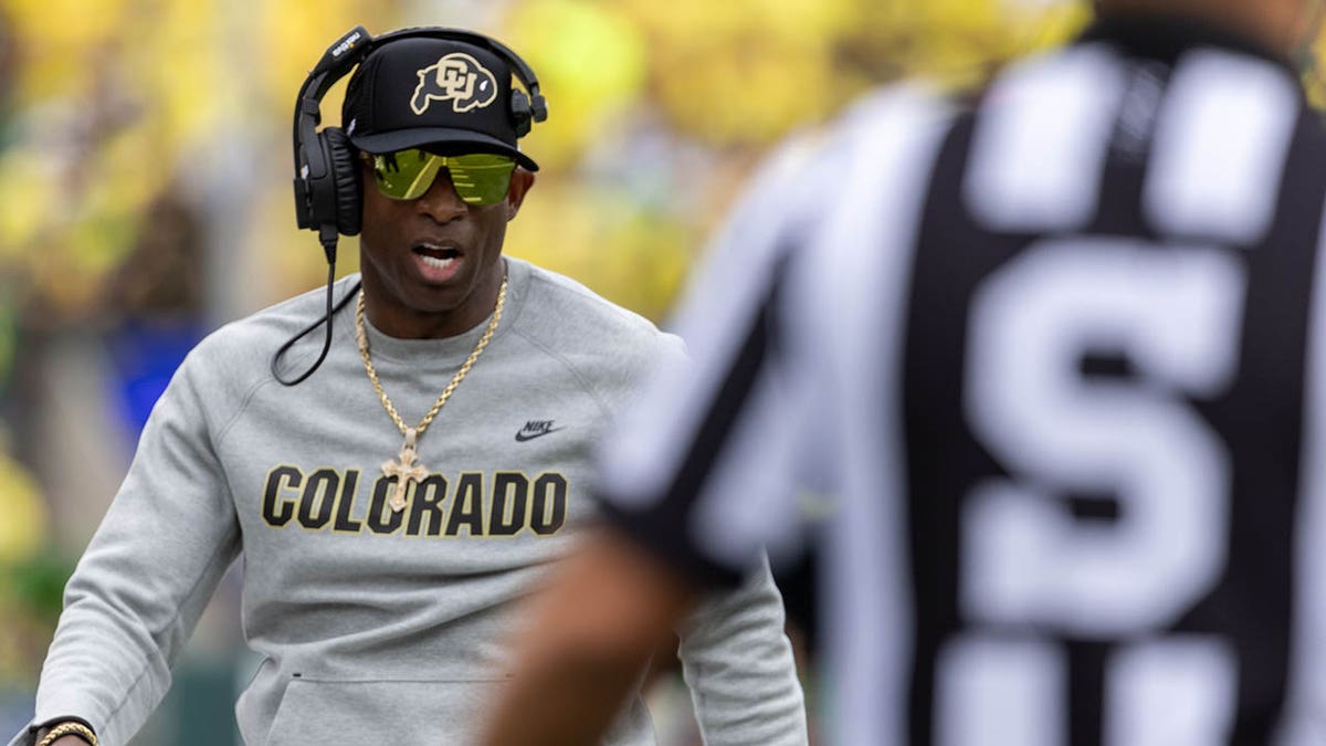 Deion Sanders walks on the field