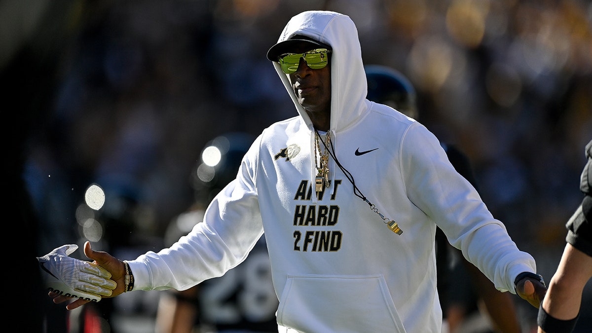 Deion Sanders greets players